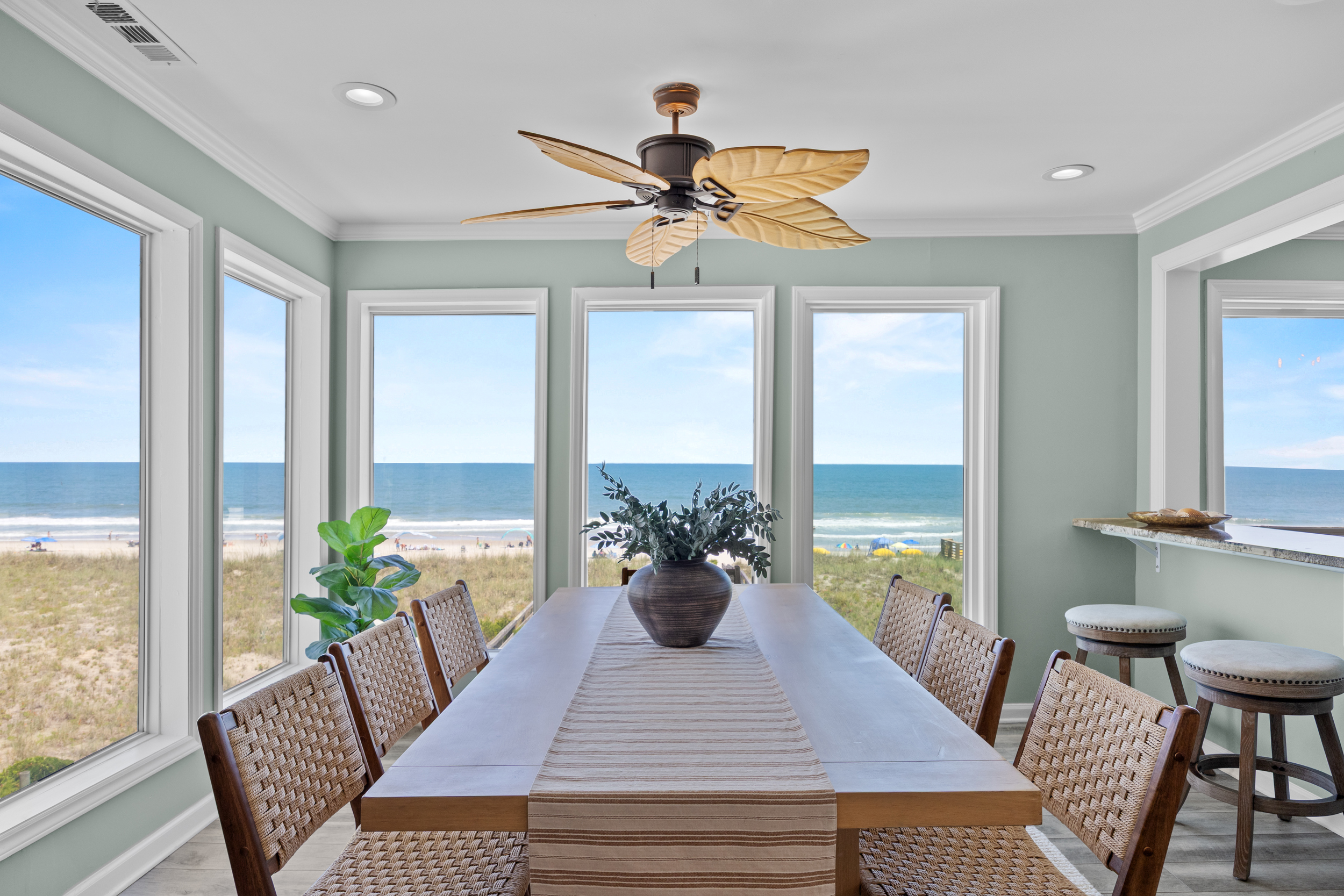 Dining table set in the window bay overlooking the dunes and Atlantic