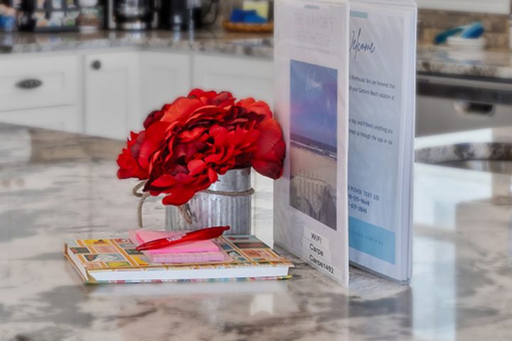 Welcome book and fresh roses on the kitchen counter