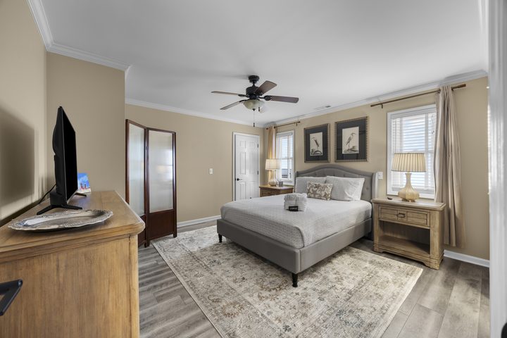 Guest suite with upholstered king bed and heron prints