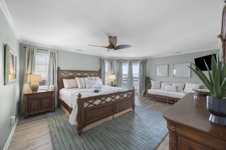 Primary suite with carved four-poster king bed
