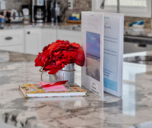 Welcome book and fresh roses on the kitchen counter